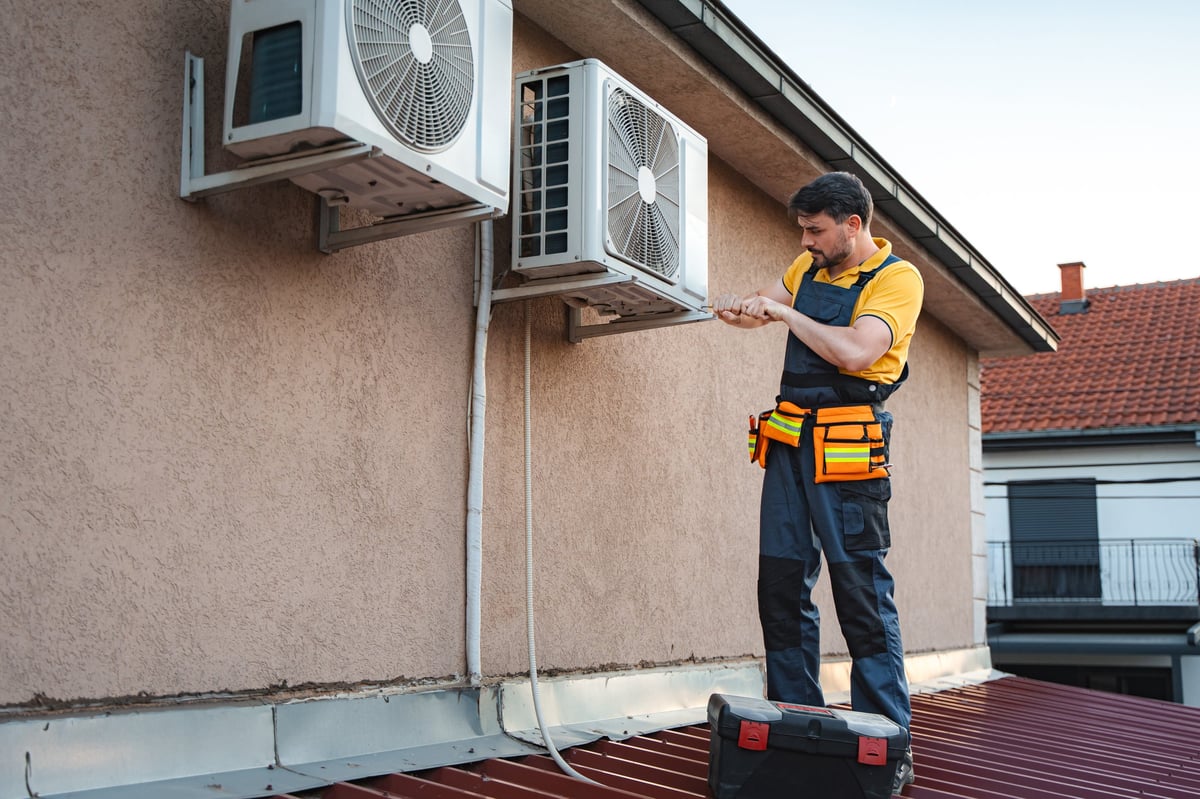 Technician installing an air conditioning unit